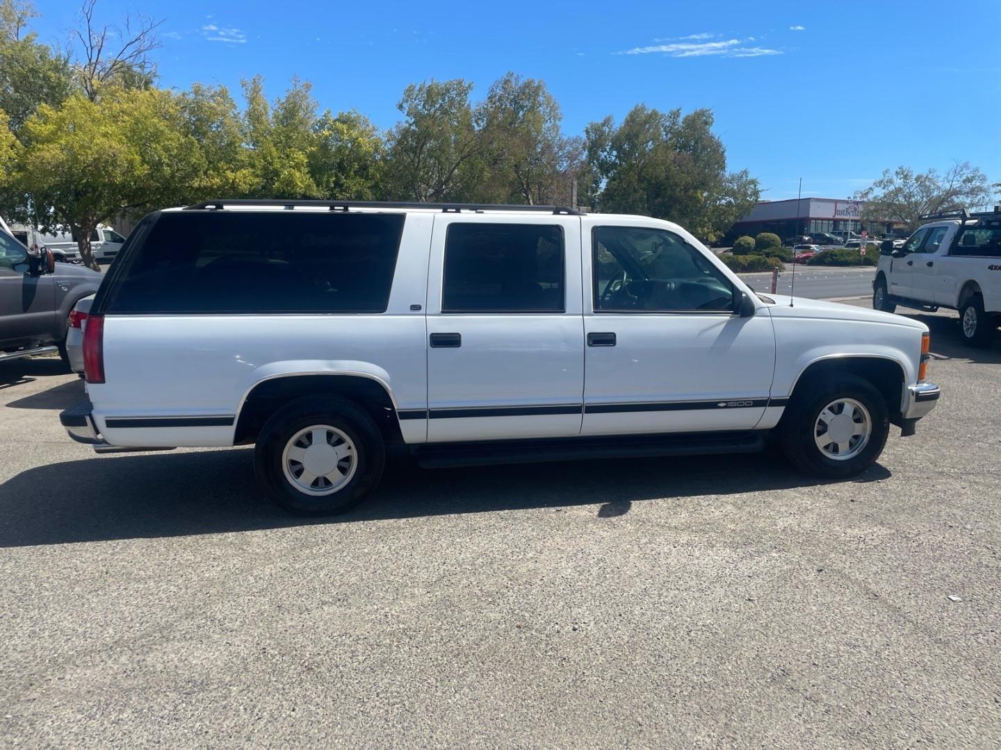 1999 White Chevrolet Suburban LT (1GNEC16R5XJ) with an 8 Cylinder Other engine, 5-Speed Automatic transmission, located at 800 Riverside Ave, Roseville, CA, 95678, 916-773-4549 & Toll Free: 866-719-4393, 38.732265, -121.291039 - LT 8 PASSENGER NEW TIRES LOW MILES CLEAN CARFAX- Photo#5