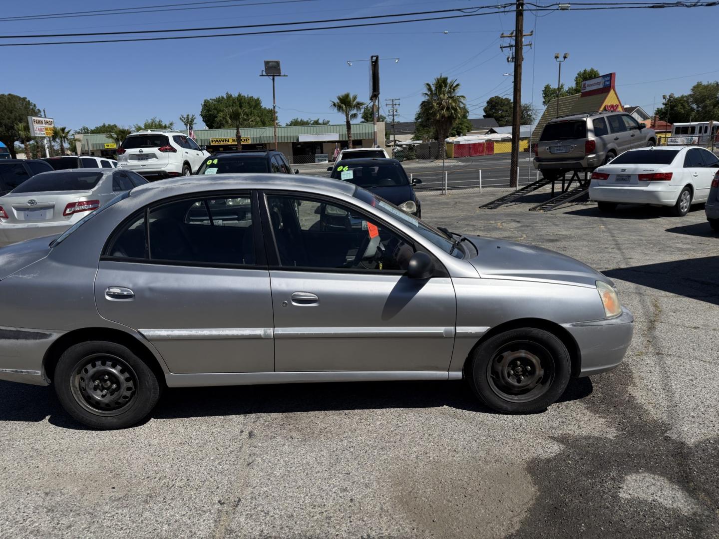 2004 Kia Rio Sedan (KNADC125646) with an 1.6L L4 DOHC 16V engine, located at 44356 Date Ave., Lancaster, CA, 93534, (661) 945-6555, 34.688919, -118.139374 - Photo#2
