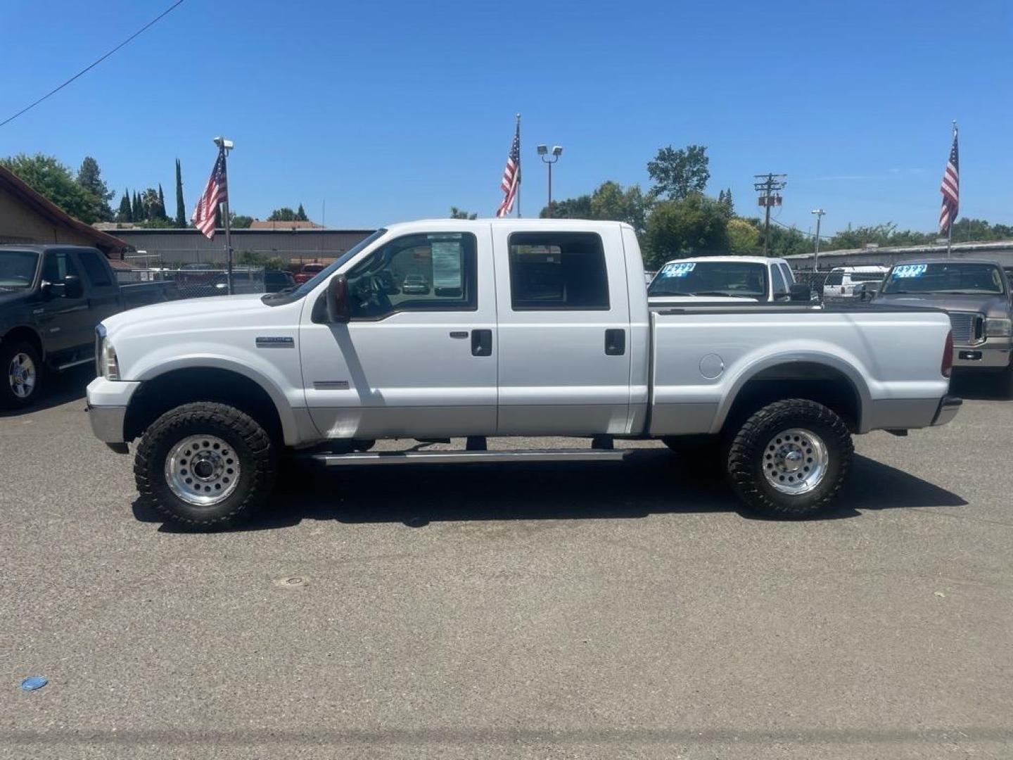 2006 Oxford White Clearcoat/Silver Clearcoat Metallic Ford F-350 Super Duty Lariat (1FTWW31PX6E) with an 6.0L Power Stroke 6.0L Diesel Turbo V8 325hp 560ft. lbs. Direct Injection engine, 5-Speed Automatic transmission, located at 800 Riverside Ave, Roseville, CA, 95678, 916-773-4549 & Toll Free: 866-719-4393, 38.732265, -121.291039 - DIESEL CREW CAB 4X4 LARIAT LIFTED - Photo#4