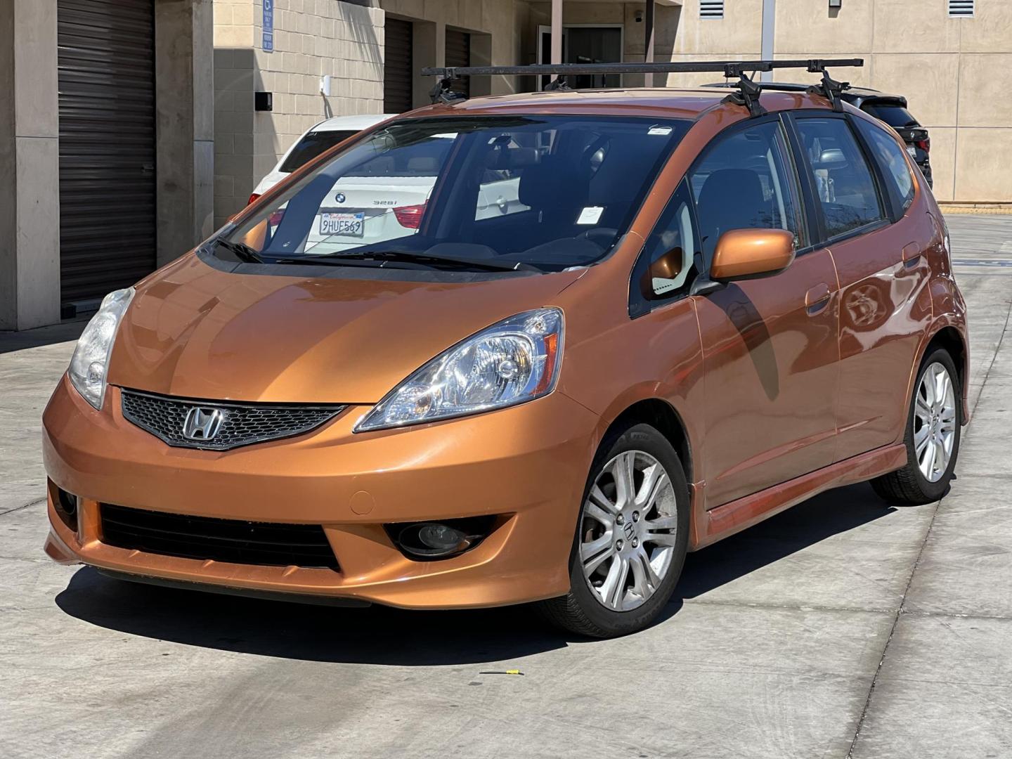 2010 Orange Revolution Metallic /Gray Honda Fit Sport 5-Speed AT (JHMGE8H48AC) with an 1.5L L4 SOHC 16V engine, 5-Speed Automatic transmission, located at 30 S. Berkeley Avenue, Pasadena, CA, 91107, (626) 248-7567, 34.145447, -118.109398 - 2010 Honda Fit for Sale at Crown City Motors - Pasadena, CA Looking for a reliable, fuel-efficient, and versatile compact car? Discover the 2010 Honda Fit, now available at Crown City Motors, located at 30 S Berkeley Ave, Pasadena, CA 91107. This vibrant subcompact hatchback, renowned for its pract - Photo#0