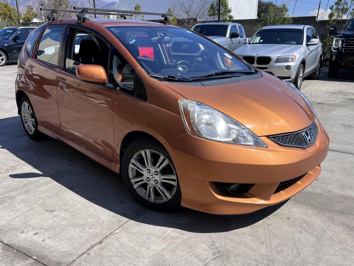 2010 Orange Revolution Metallic /Gray Honda Fit Sport 5-Speed AT (JHMGE8H48AC) with an 1.5L L4 SOHC 16V engine, 5-Speed Automatic transmission, located at 30 S. Berkeley Avenue, Pasadena, CA, 91107, (626) 248-7567, 34.145447, -118.109398 - 2010 Honda Fit for Sale at Crown City Motors - Pasadena, CA Looking for a reliable, fuel-efficient, and versatile compact car? Discover the 2010 Honda Fit, now available at Crown City Motors, located at 30 S Berkeley Ave, Pasadena, CA 91107. This vibrant subcompact hatchback, renowned for its pract - Photo#2