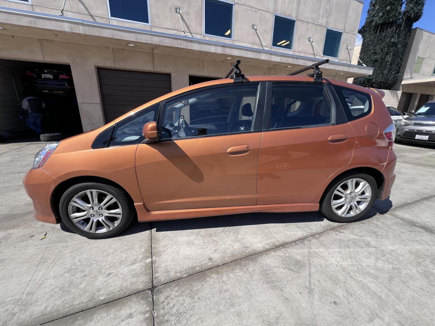 2010 Orange Revolution Metallic /Gray Honda Fit Sport 5-Speed AT (JHMGE8H48AC) with an 1.5L L4 SOHC 16V engine, 5-Speed Automatic transmission, located at 30 S. Berkeley Avenue, Pasadena, CA, 91107, (626) 248-7567, 34.145447, -118.109398 - 2010 Honda Fit for Sale at Crown City Motors - Pasadena, CA Looking for a reliable, fuel-efficient, and versatile compact car? Discover the 2010 Honda Fit, now available at Crown City Motors, located at 30 S Berkeley Ave, Pasadena, CA 91107. This vibrant subcompact hatchback, renowned for its pract - Photo#3