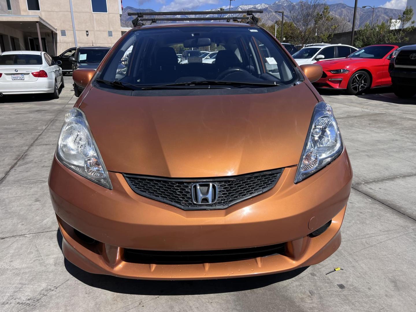 2010 Orange Revolution Metallic /Gray Honda Fit Sport 5-Speed AT (JHMGE8H48AC) with an 1.5L L4 SOHC 16V engine, 5-Speed Automatic transmission, located at 30 S. Berkeley Avenue, Pasadena, CA, 91107, (626) 248-7567, 34.145447, -118.109398 - 2010 Honda Fit for Sale at Crown City Motors - Pasadena, CA Looking for a reliable, fuel-efficient, and versatile compact car? Discover the 2010 Honda Fit, now available at Crown City Motors, located at 30 S Berkeley Ave, Pasadena, CA 91107. This vibrant subcompact hatchback, renowned for its pract - Photo#8