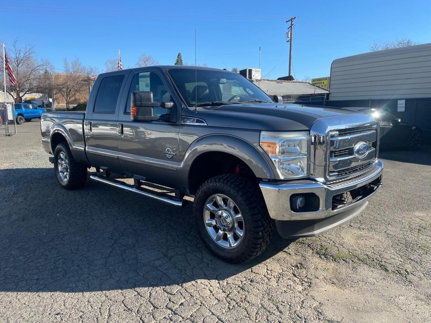 2011 Sterling Grey Metallic Ford F-250 Super Duty Lariat (1FT7W2BT3BE) with an 6.7L Power Stroke 6.7L Biodiesel Turbo V8 400hp 800ft. lbs. Common Rail Direct Injection engine, 6-Speed Shiftable Automatic transmission, located at 800 Riverside Ave, Roseville, CA, 95678, 916-773-4549 & Toll Free: 866-719-4393, 38.732265, -121.291039 - DIESEL CREW CAB 4X4 FX4 NEW TIRES SERVICE RECORDS - Photo#1