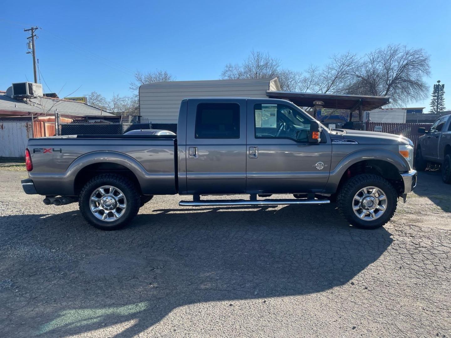 2011 Sterling Grey Metallic Ford F-250 Super Duty Lariat (1FT7W2BT3BE) with an 6.7L Power Stroke 6.7L Biodiesel Turbo V8 400hp 800ft. lbs. Common Rail Direct Injection engine, 6-Speed Shiftable Automatic transmission, located at 800 Riverside Ave, Roseville, CA, 95678, 916-773-4549 & Toll Free: 866-719-4393, 38.732265, -121.291039 - DIESEL CREW CAB 4X4 FX4 NEW TIRES SERVICE RECORDS - Photo#4