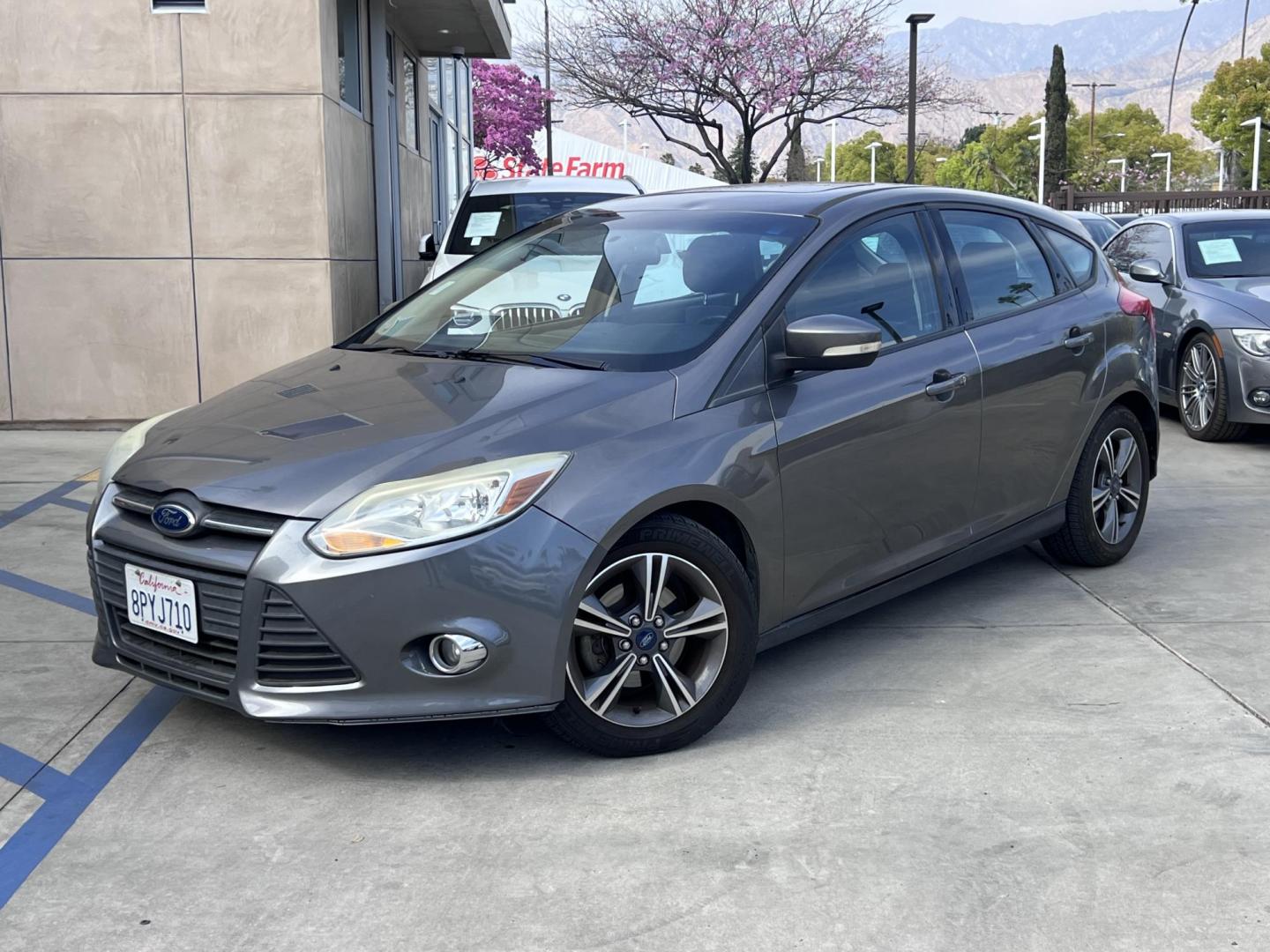 2014 Gray /Balck Ford Focus SE Hatch (1FADP3K21EL) with an 2.0L L4 DOHC 16V engine, Automatic transmission, located at 30 S. Berkeley Avenue, Pasadena, CA, 91107, (626) 248-7567, 34.145447, -118.109398 - Microsoft Sync! Moon-roof! This 2014 Ford Focus SE Hatch looks and drives good. Bad credit? We can help! We are the bank. - Photo#0