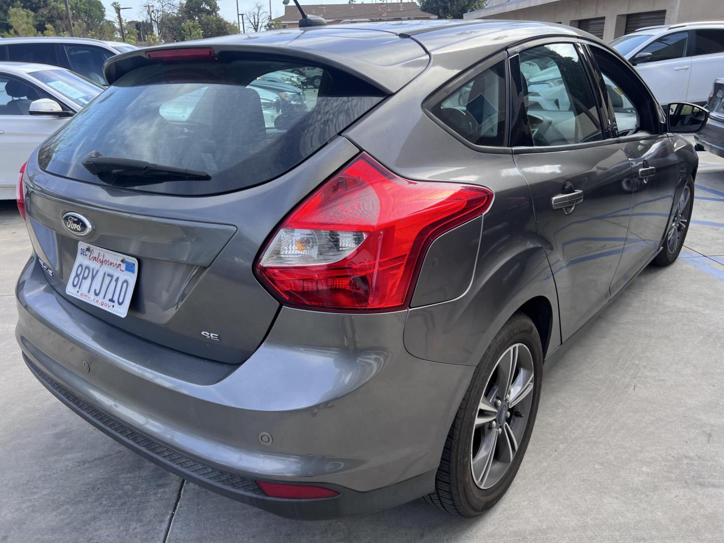 2014 Gray /Balck Ford Focus SE Hatch (1FADP3K21EL) with an 2.0L L4 DOHC 16V engine, Automatic transmission, located at 30 S. Berkeley Avenue, Pasadena, CA, 91107, (626) 248-7567, 34.145447, -118.109398 - Microsoft Sync! Moon-roof! This 2014 Ford Focus SE Hatch looks and drives good. Bad credit? We can help! We are the bank. - Photo#5
