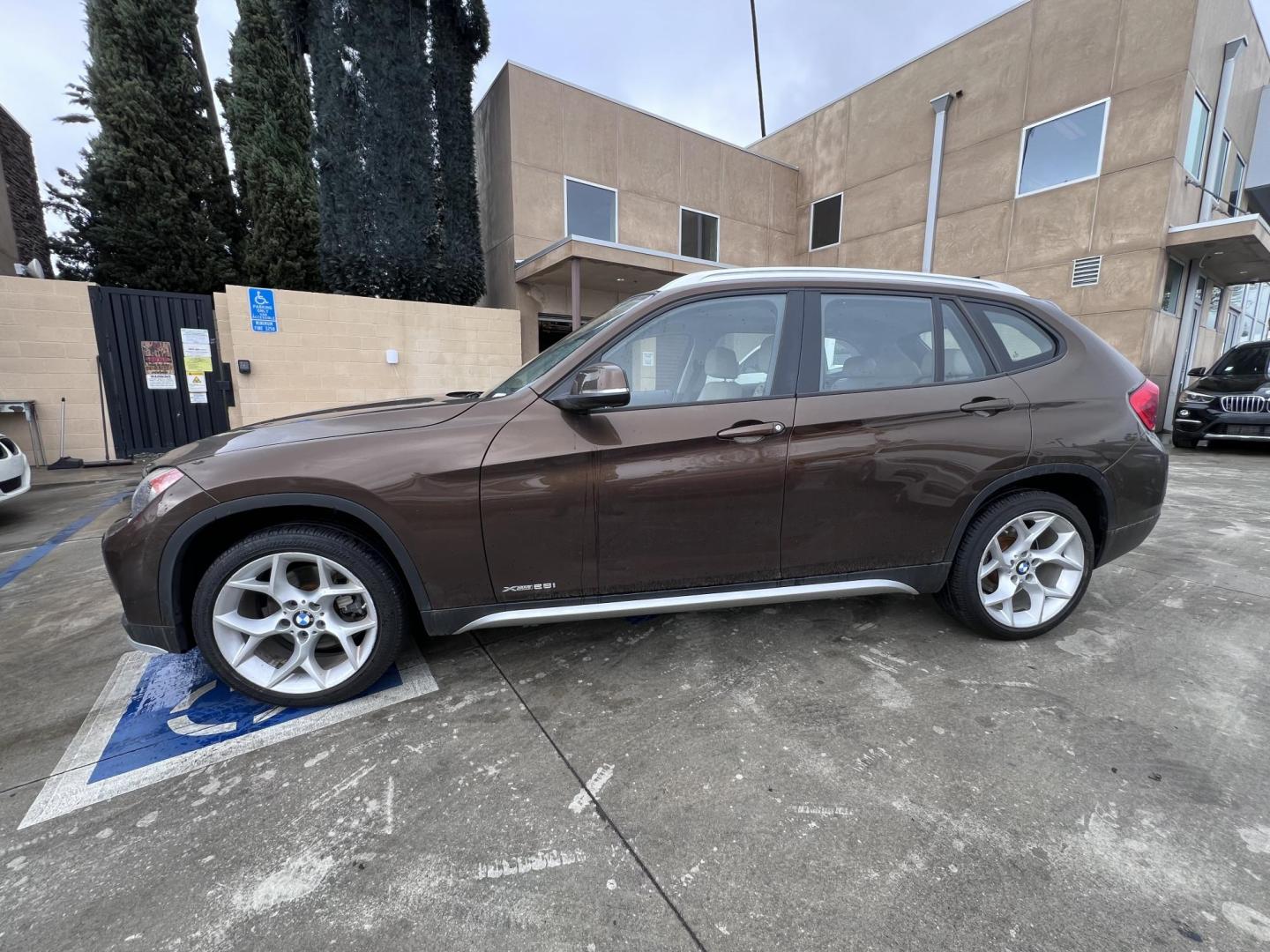 2015 Sparkling Brown Metallic /Tan BMW X1 xDrive28i (WBAVL1C58FV) with an 2.0L L4 DOHC 16V engine, 8-Speed Automatic transmission, located at 30 S. Berkeley Avenue, Pasadena, CA, 91107, (626) 248-7567, 34.145447, -118.109398 - Low Miles! Navigation! Panaramic-roof! Back-up camera! AWD! 2015 BMW X1 for Sale - Low Miles! Navigation! Panoramic Roof! Back-Up Camera! AWD! Discover the Perfect Pre-Owned BMW at Crown City Motors Are you in the market for a luxury SUV that combines performance, elegance, and advanced feat - Photo#1