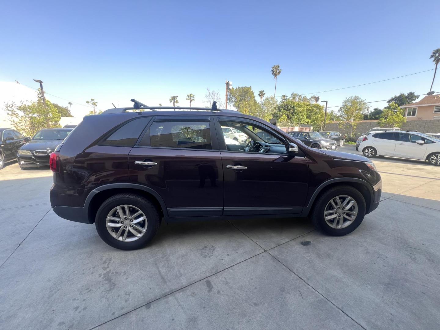 2015 Dark Cherry Pearl /Tan Kia Sorento LX 2WD (5XYKT3A69FG) with an 2.4L L4 DOHC 16V engine, 6-Speed Automatic transmission, located at 30 S. Berkeley Avenue, Pasadena, CA, 91107, (626) 248-7567, 34.145447, -118.109398 - 2015 Kia Sorento – Affordable, Reliable, and Stylish SUV in Pasadena, CA | Buy Here Pay Here Available Looking for a dependable and stylish SUV that won't break the bank? Crown City Motors in Pasadena, CA is proud to offer this 2015 Kia Sorento in a stunning burgundy finish (Dark Cherry Pearl / R - Photo#4