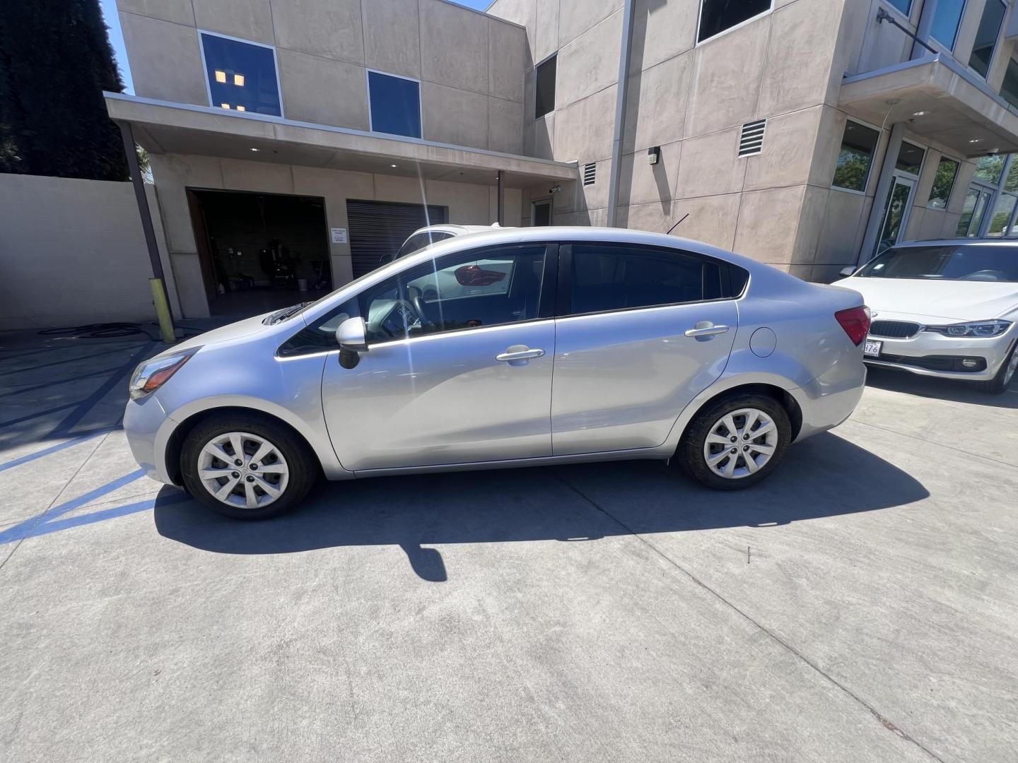2015 Silver Metallic /Black Kia Rio LX (KNADM4A33F6) with an 1.6L L4 DOHC 16V engine, Maual transmission, located at 30 S. Berkeley Avenue, Pasadena, CA, 91107, (626) 248-7567, 34.145447, -118.109398 - 2015 Kia Rio LX – Fuel-Efficient Compact Sedan – $995 Down – Buy Here Pay Here – Bad Credit OK – Crown City Motors – Pasadena, CA Looking for a clean, fuel-efficient, and affordable sedan that gets you from point A to B with style and reliability? This 2015 Kia Rio LX is the perfect d - Photo#1
