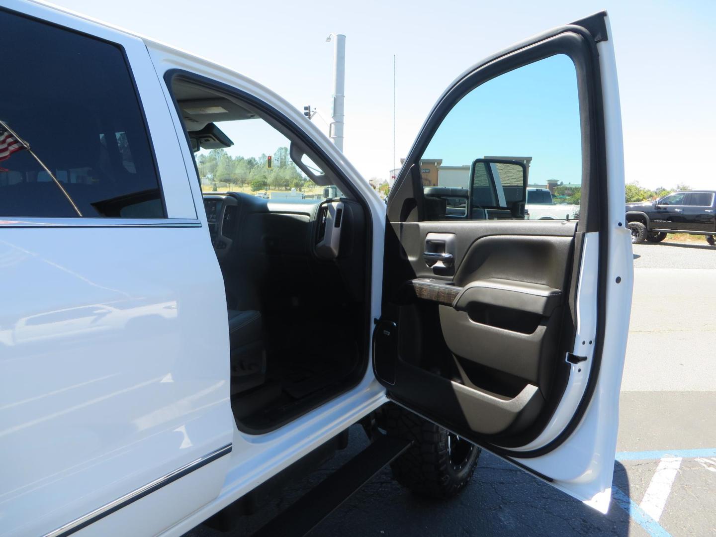 2016 GMC Sierra 2500HD Denali Crew Cab 4WD (1GT12UE8XGF) with an 6.6L V8 OHV 16 DIESEL engine, 6A transmission, located at 2630 Grass Valley Highway, Auburn, CA, 95603, (530) 508-5100, 38.937893, -121.095482 - Lifted Denali 2500 featuring a Pro Comp 6" lift kit, 20" Fuel Nutz wheels, 35" Nitto Ridge Grappler tires, Amp power steps, and Weathertech floor liners. - Photo#56
