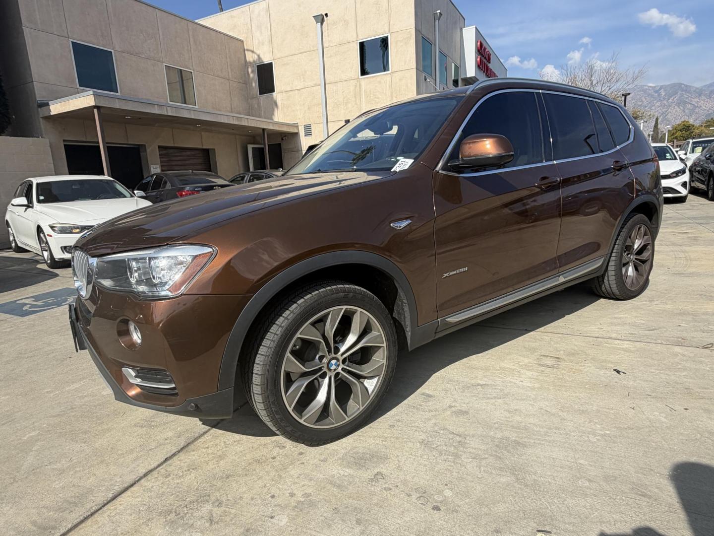 2017 Barcelona Red Metallic BMW X3 xDrive28i (5UXWX9C56H0) with an 2.0L L4 DOHC 16V engine, 8A transmission, located at 30 S. Berkeley Avenue, Pasadena, CA, 91107, (626) 248-7567, 34.145447, -118.109398 - Crown City Motors is a used “Buy Here Pay Here” car dealer in Pasadena CA. “Buy Here Pay Here” financing, means that when you purchase your vehicle from our dealership, that you make the payments to the dealership as well. We do not need the banks approval to get you approved for a used auto - Photo#0