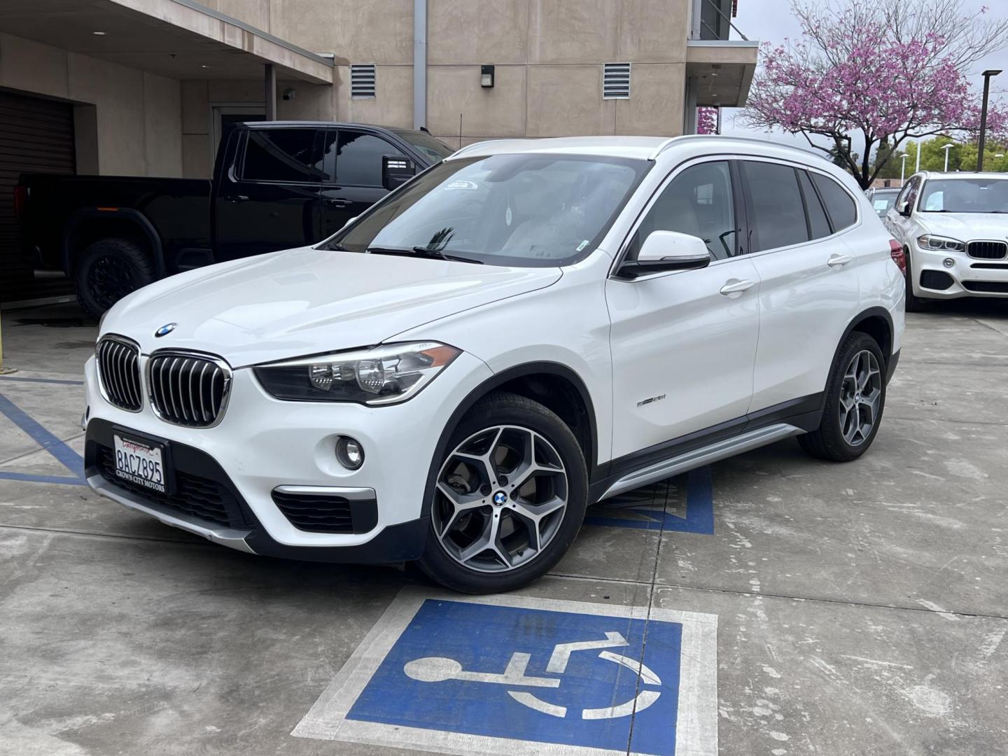 2018 White /Beige BMW X1 sDrive28i (WBXHU7C38J5) with an 2.0L L4 DOHC 16V engine, 8A transmission, located at 30 S. Berkeley Avenue, Pasadena, CA, 91107, (626) 248-7567, 34.145447, -118.109398 - Crown City Motors is a used “Buy Here Pay Here” car dealer in Pasadena CA. “Buy Here Pay Here” financing, means that when you purchase your vehicle from our dealership, that you make the payments to the dealership as well. We do not need the banks approval to get you approved for a used auto - Photo#0