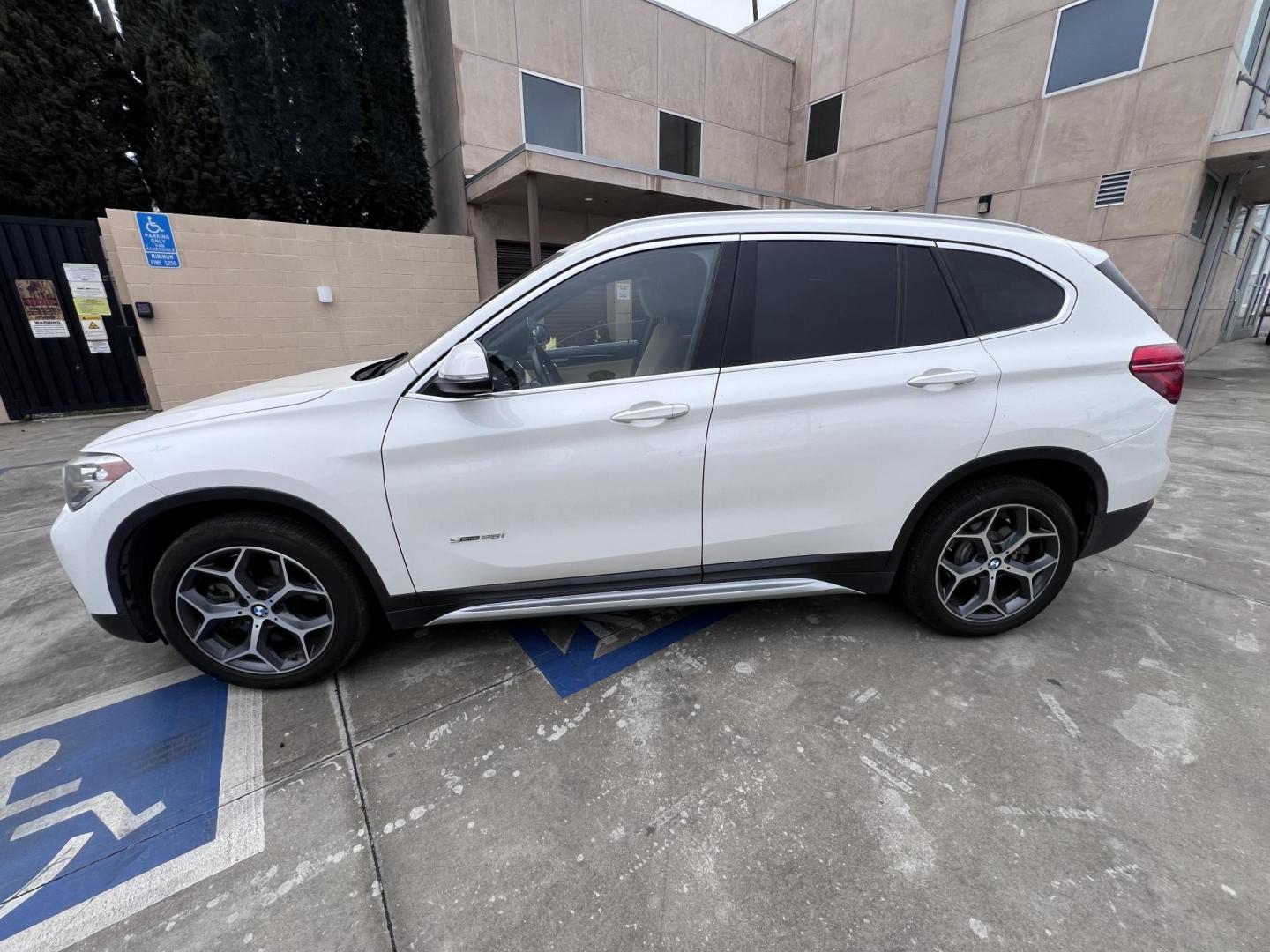 2018 White /Beige BMW X1 sDrive28i (WBXHU7C38J5) with an 2.0L L4 DOHC 16V engine, 8A transmission, located at 30 S. Berkeley Avenue, Pasadena, CA, 91107, (626) 248-7567, 34.145447, -118.109398 - Crown City Motors is a used “Buy Here Pay Here” car dealer in Pasadena CA. “Buy Here Pay Here” financing, means that when you purchase your vehicle from our dealership, that you make the payments to the dealership as well. We do not need the banks approval to get you approved for a used auto - Photo#1