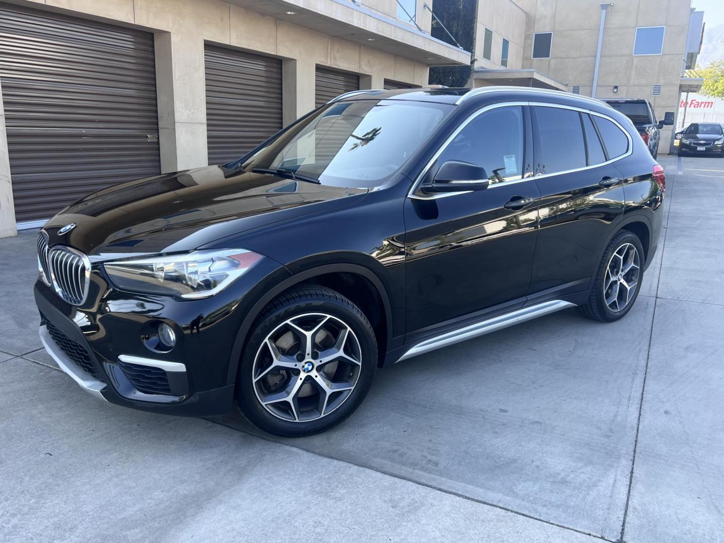 2018 BLACK /Black BMW X1 sDrive28i (WBXHU7C34J5) with an 2.0L L4 DOHC 16V engine, 8A transmission, located at 30 S. Berkeley Avenue, Pasadena, CA, 91107, (626) 248-7567, 34.145447, -118.109398 - 018 BMW X1 sDrive28i – Luxury, Performance and Affordability | Buy Here Pay Here – Pasadena, CA Step into luxury, style, and versatility with this 2018 BMW X1 sDrive28i, available now at Crown City Motors, Pasadena’s trusted Buy Here Pay Here (BHPH) dealership. Whether you're dealing with b - Photo#0