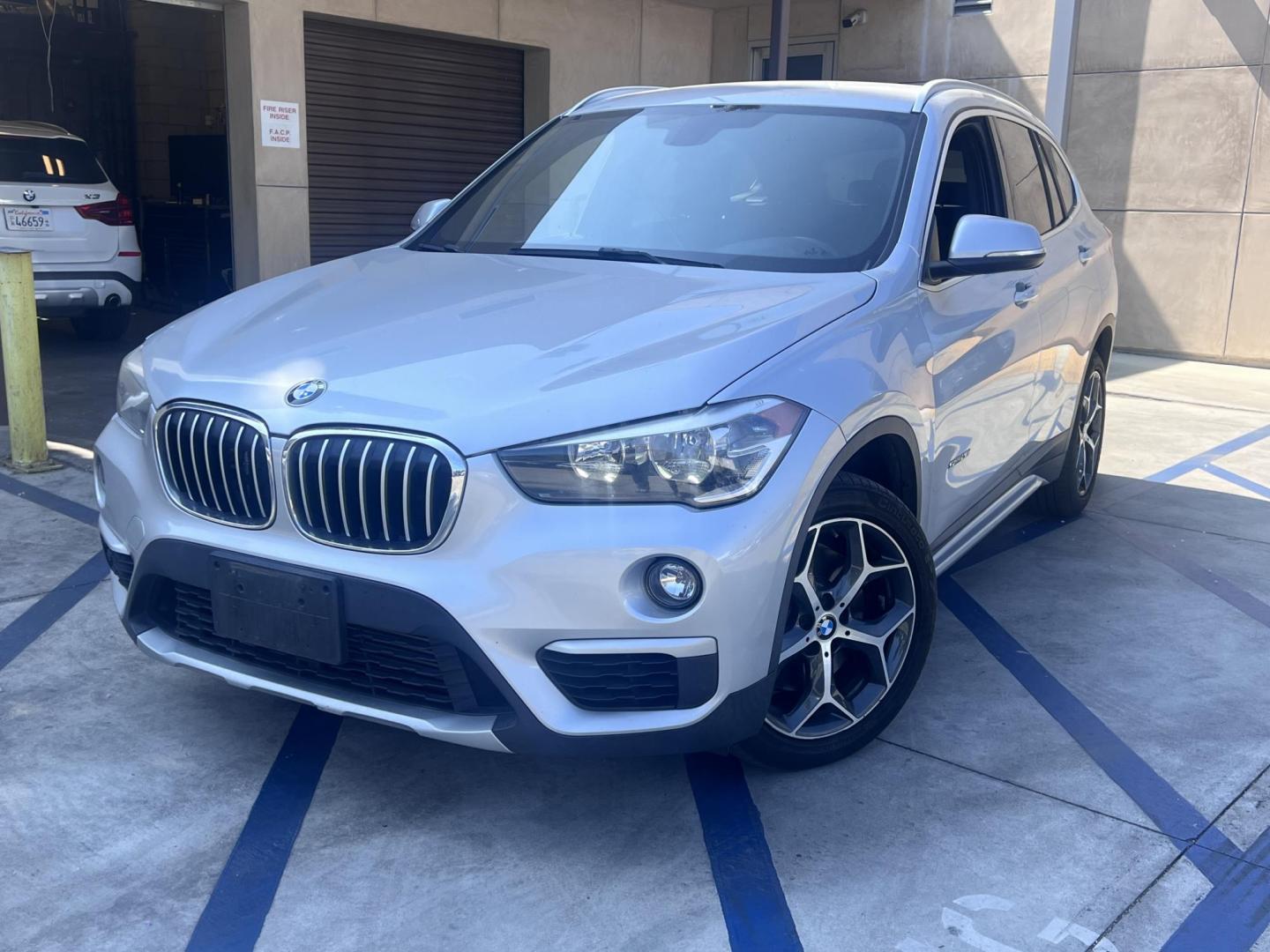 2018 Silver Metallic /Black BMW X1 sDrive28i (WBXHU7C34J5) with an 2.0L L4 DOHC 16V engine, 8A transmission, located at 30 S. Berkeley Avenue, Pasadena, CA, 91107, (626) 248-7567, 34.145447, -118.109398 - 2018 BMW X1 xDrive28i – Luxury, Performance, and Affordability in One SUV VIN: WBXHU7C34J5H42594 Location: Crown City Motors, Pasadena, CA Status: Available Now – Clean Title – Financing Options for All Credit Types Looking for a luxury crossover SUV that combines sporty performance, ele - Photo#0