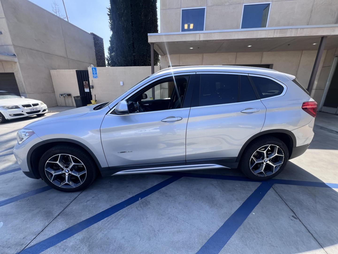 2018 Silver Metallic /Black BMW X1 sDrive28i (WBXHU7C34J5) with an 2.0L L4 DOHC 16V engine, 8A transmission, located at 30 S. Berkeley Avenue, Pasadena, CA, 91107, (626) 248-7567, 34.145447, -118.109398 - 2018 BMW X1 xDrive28i – Luxury, Performance, and Affordability in One SUV VIN: WBXHU7C34J5H42594 Location: Crown City Motors, Pasadena, CA Status: Available Now – Clean Title – Financing Options for All Credit Types Looking for a luxury crossover SUV that combines sporty performance, ele - Photo#1