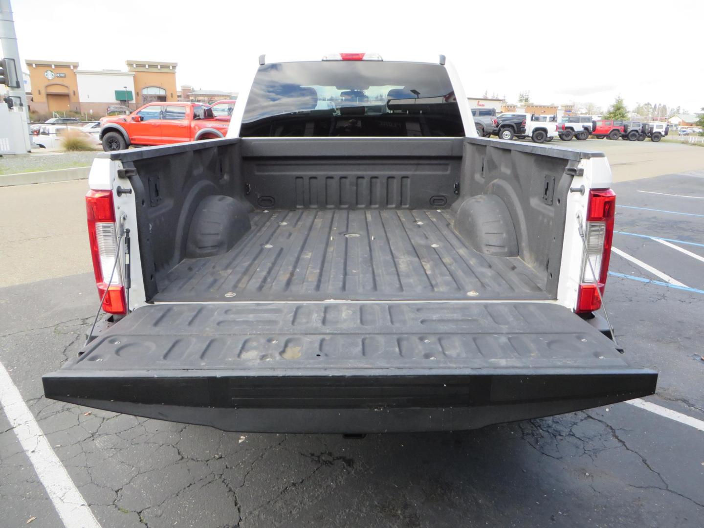 2019 White Ford F-250 SD XLT Crew Cab Short Bed 4WD (1FT7W2BT9KE) with an 6.7L V8 OHV 16V DIESEL engine, 6A transmission, located at 2630 Grass Valley Highway, Auburn, CA, 95603, (530) 508-5100, 38.937893, -121.095482 - Leveled XLT sitting on 22" SOTA Novakane wheels, 325 Nitto Ridge Grappler tires, Fox Shocks and dual steering stabilizers, Firestone Ride Rite air bags, Airlift wireless 1 air compressor, B and W Turnover gooseneck hitch, Weathertech floor liners, Deezee tailgate assist, and window tint. - Photo#15