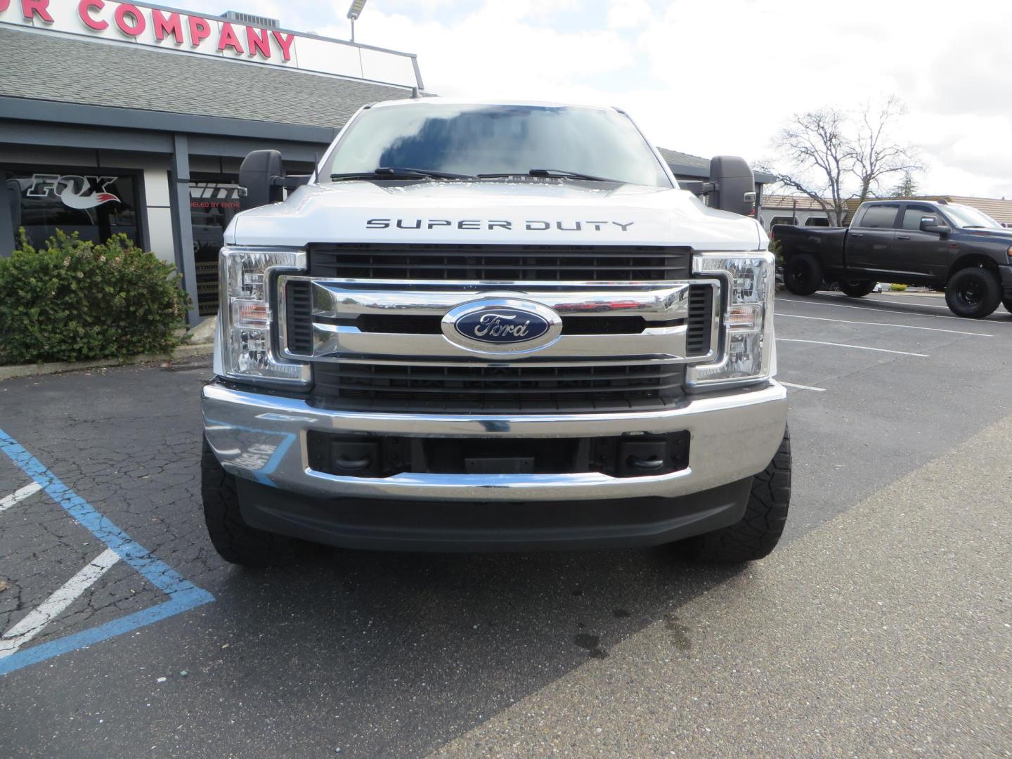2019 White Ford F-250 SD XLT Crew Cab Short Bed 4WD (1FT7W2BT9KE) with an 6.7L V8 OHV 16V DIESEL engine, 6A transmission, located at 2630 Grass Valley Highway, Auburn, CA, 95603, (530) 508-5100, 38.937893, -121.095482 - Leveled XLT sitting on 22" SOTA Novakane wheels, 325 Nitto Ridge Grappler tires, Fox Shocks and dual steering stabilizers, Firestone Ride Rite air bags, Airlift wireless 1 air compressor, B and W Turnover gooseneck hitch, Weathertech floor liners, Deezee tailgate assist, and window tint. - Photo#1