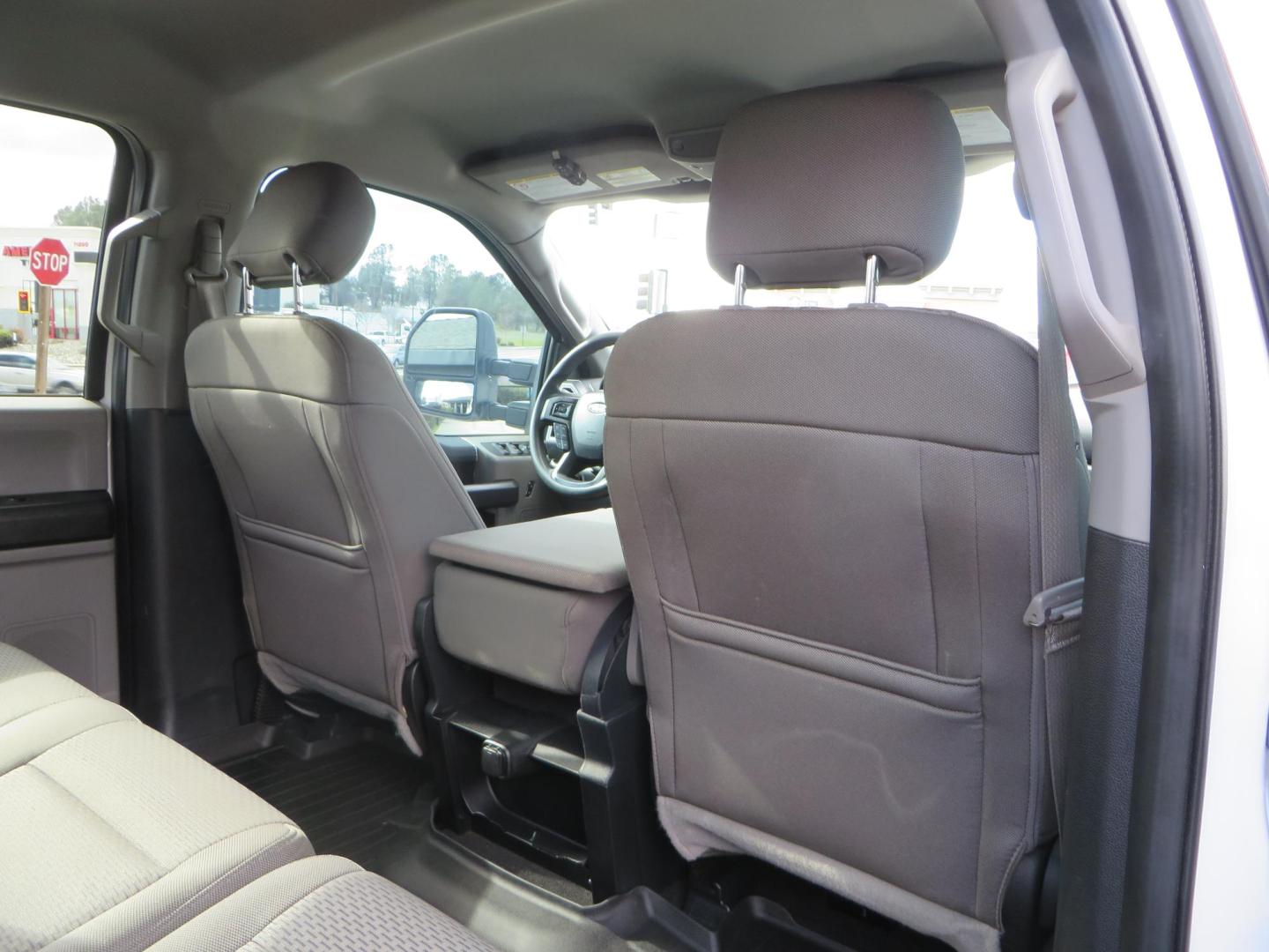 2019 White Ford F-250 SD XLT Crew Cab Short Bed 4WD (1FT7W2BT9KE) with an 6.7L V8 OHV 16V DIESEL engine, 6A transmission, located at 2630 Grass Valley Highway, Auburn, CA, 95603, (530) 508-5100, 38.937893, -121.095482 - Leveled XLT sitting on 22" SOTA Novakane wheels, 325 Nitto Ridge Grappler tires, Fox Shocks and dual steering stabilizers, Firestone Ride Rite air bags, Airlift wireless 1 air compressor, B and W Turnover gooseneck hitch, Weathertech floor liners, Deezee tailgate assist, and window tint. - Photo#61