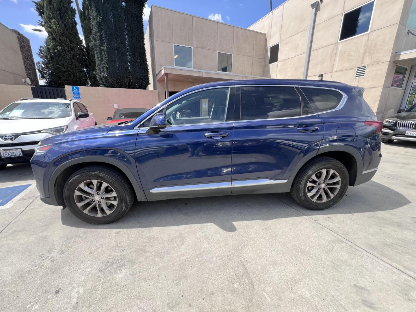 2019 Stormy BLue /Black Hyundai Santa Fe SEL 2.4 (5NMS33AD0KH) with an 2.4L L4 DOHC 16V engine, 8A transmission, located at 30 S. Berkeley Avenue, Pasadena, CA, 91107, (626) 248-7567, 34.145447, -118.109398 - Are you in the market for a stylish, reliable, and family-friendly SUV? Look no further than this 2019 Hyundai Santa Fe, available now at Crown City Motors, located at 30 S Berkeley Ave, Pasadena, CA 91107. As a premier Buy Here Pay Here dealership in Pasadena, we’re proud to offer this exceptiona - Photo#2