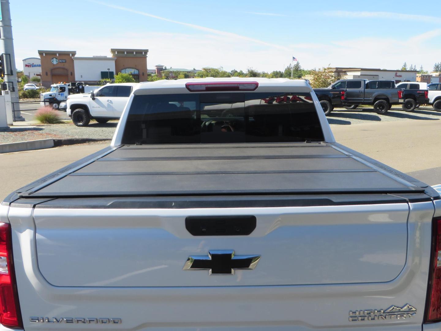 2021 White Chevrolet Silverado 1500 High Country Crew Cab 4WD (3GCUYHEL2MG) with an 6.2L V8 OHV 16V engine, 6A transmission, located at 2630 Grass Valley Highway, Auburn, CA, 95603, (530) 508-5100, 38.937893, -121.095482 - Features - Zone Offroad 6" lift kit, 35" Nitto Ridge Grappler tires, 20" SOTA wheels, and a Bakflip MX4 bedcover. - Photo#13