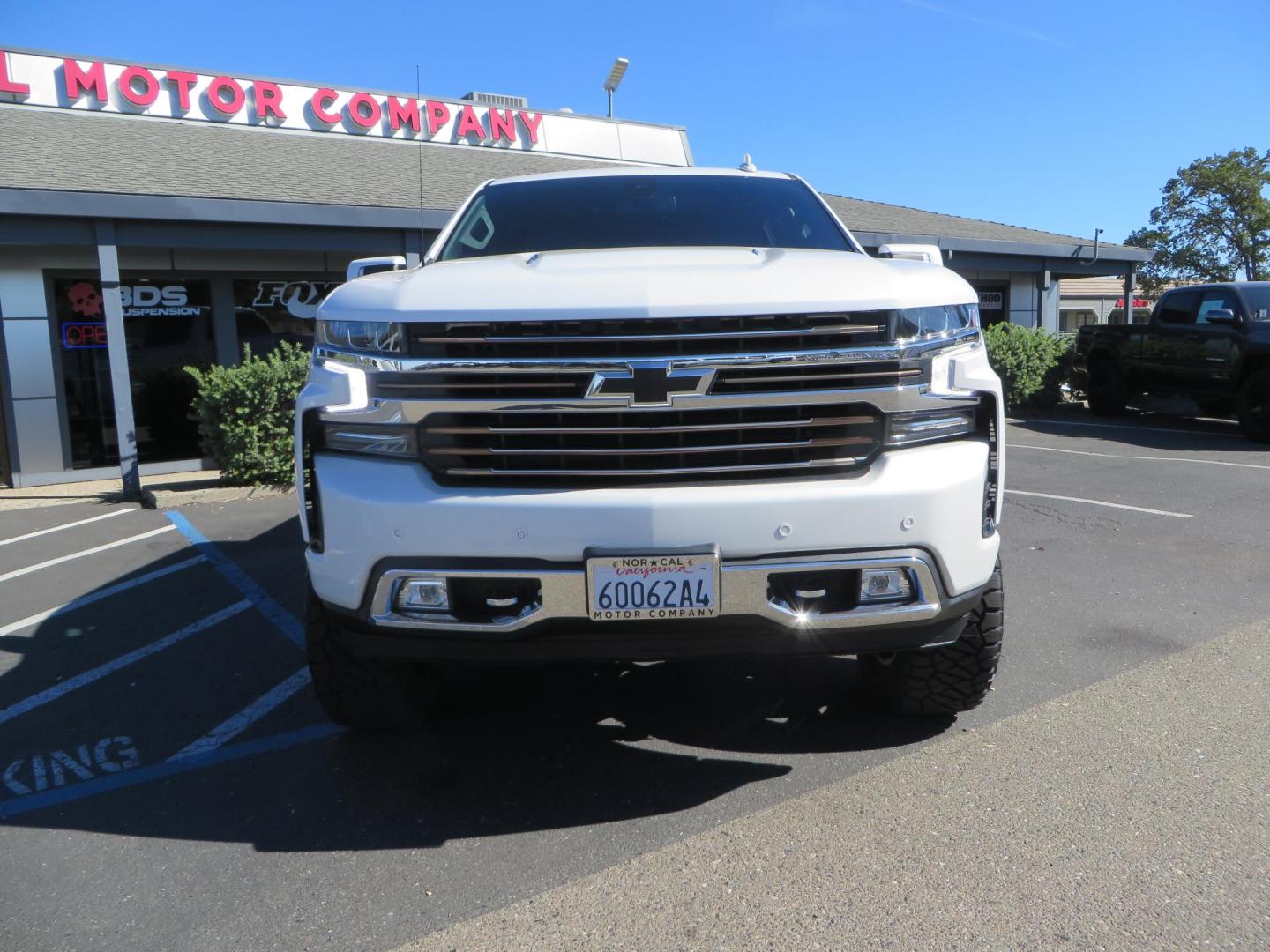 2021 White Chevrolet Silverado 1500 High Country Crew Cab 4WD (3GCUYHEL2MG) with an 6.2L V8 OHV 16V engine, 6A transmission, located at 2630 Grass Valley Highway, Auburn, CA, 95603, (530) 508-5100, 38.937893, -121.095482 - Features - Zone Offroad 6" lift kit, 35" Nitto Ridge Grappler tires, 20" SOTA wheels, and a Bakflip MX4 bedcover. - Photo#1