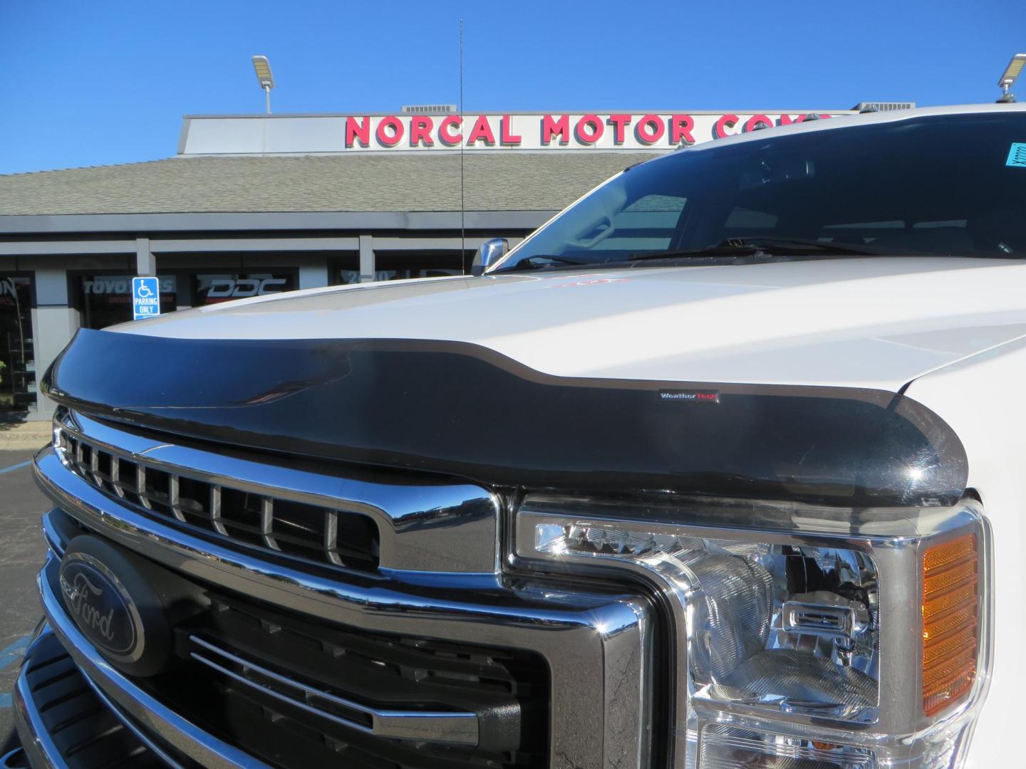 2021 White /BLACK Ford F-250 SD Lariat Crew Cab 4WD (1FT7W2BTXME) with an 6.7L V8 OHV 16V DIESEL engine, 6A transmission, located at 2630 Grass Valley Highway, Auburn, CA, 95603, (530) 508-5100, 38.937893, -121.095482 - Features a BDS level kit with Fox 2.0 shocks, 35" Toyo Open Country RT trail tires, 18" KMC IMS wheels, Weathertech Bug deflector and floor liners. - Photo#13