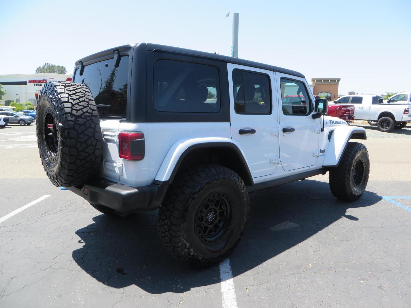 2021 White /Black Jeep Wrangler Unlimited Rubicon 4XE (1C4JJXR64MW) with an 2.0L L4 DOHC 16V HYBRID engine, 8A transmission, located at 2630 Grass Valley Highway, Auburn, CA, 95603, (530) 508-5100, 38.937893, -121.095482 - Mopar lifted JL with 17" Black Rhino Kelso wheels, 37" Toyo RT Trail tires, and a Teraflex HD tire relocation. - Photo#4
