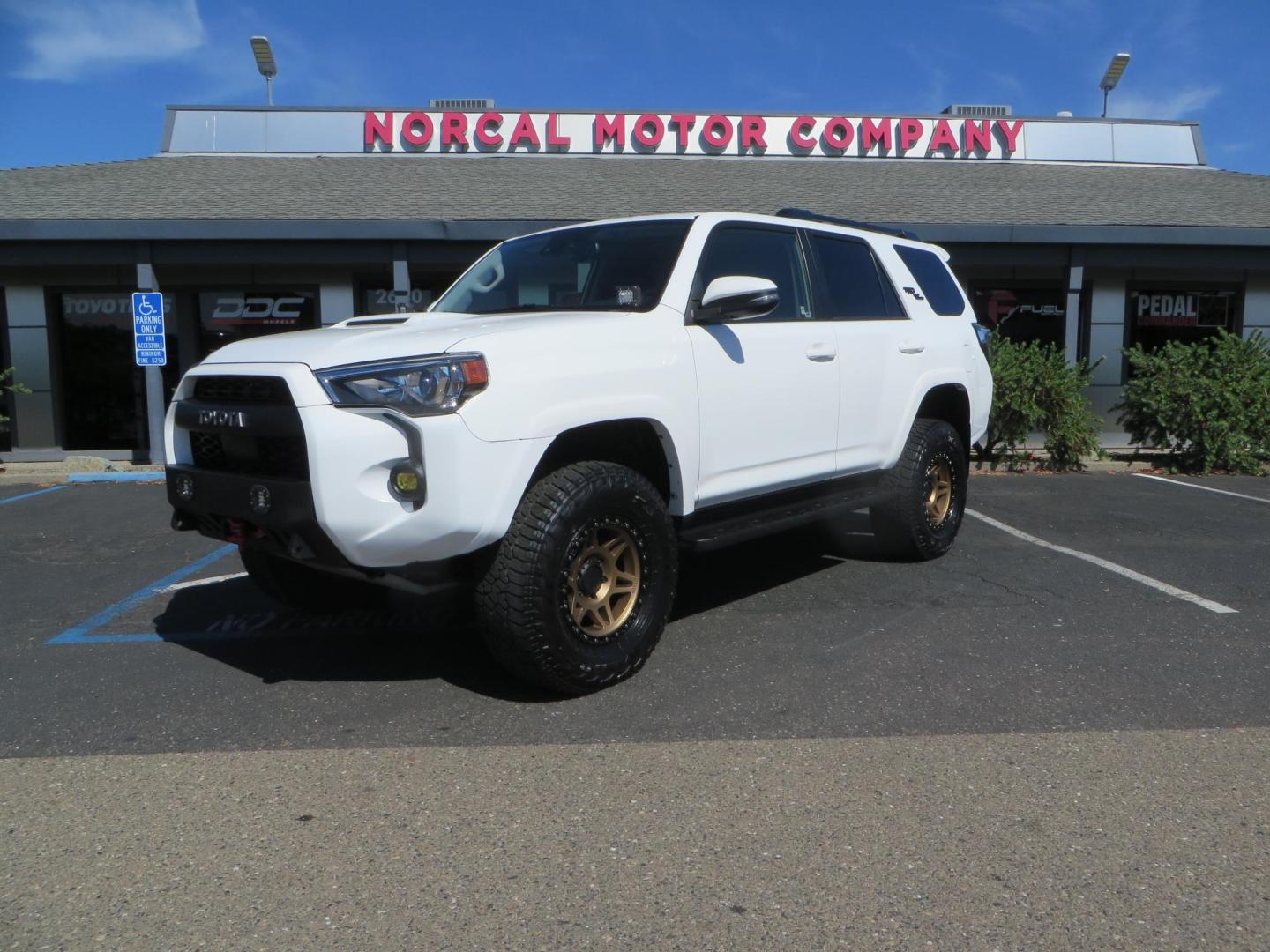 2021 White Toyota 4Runner TRD Off-road Premium 4WD (JTERU5JR5M5) with an 4.0L V6 DOHC 24V engine, 5A transmission, located at 2630 Grass Valley Highway, Auburn, CA, 95603, (530) 508-5100, 38.937893, -121.095482 - TRD Offroad Premium 4Runner ready for all of your adventures. Features Ironman suspension, 285 Falken Wildpeak AT3W tires, 17" Method Race wheels, Front winch bumper, Badlands winch, Led bumper and ditch lights, and rear cargo molle panels. - Photo#0