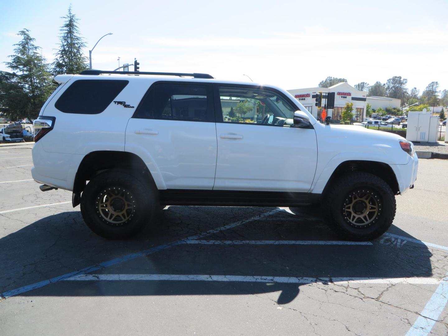 2021 White Toyota 4Runner TRD Off-road Premium 4WD (JTERU5JR5M5) with an 4.0L V6 DOHC 24V engine, 5A transmission, located at 2630 Grass Valley Highway, Auburn, CA, 95603, (530) 508-5100, 38.937893, -121.095482 - TRD Offroad Premium 4Runner ready for all of your adventures. Features Ironman suspension, 285 Falken Wildpeak AT3W tires, 17" Method Race wheels, Front winch bumper, Badlands winch, Led bumper and ditch lights, and rear cargo molle panels. - Photo#5