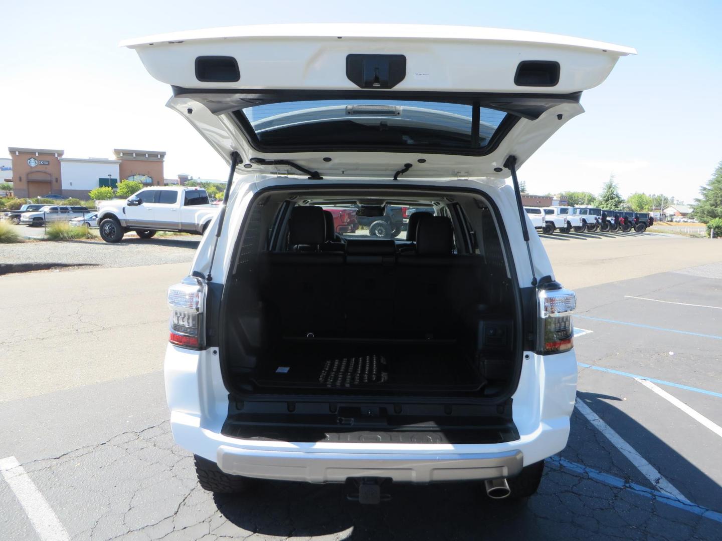 2021 White Toyota 4Runner TRD Off-road Premium 4WD (JTERU5JR5M5) with an 4.0L V6 DOHC 24V engine, 5A transmission, located at 2630 Grass Valley Highway, Auburn, CA, 95603, (530) 508-5100, 38.937893, -121.095482 - TRD Offroad Premium 4Runner ready for all of your adventures. Features Ironman suspension, 285 Falken Wildpeak AT3W tires, 17" Method Race wheels, Front winch bumper, Badlands winch, Led bumper and ditch lights, and rear cargo molle panels. - Photo#62
