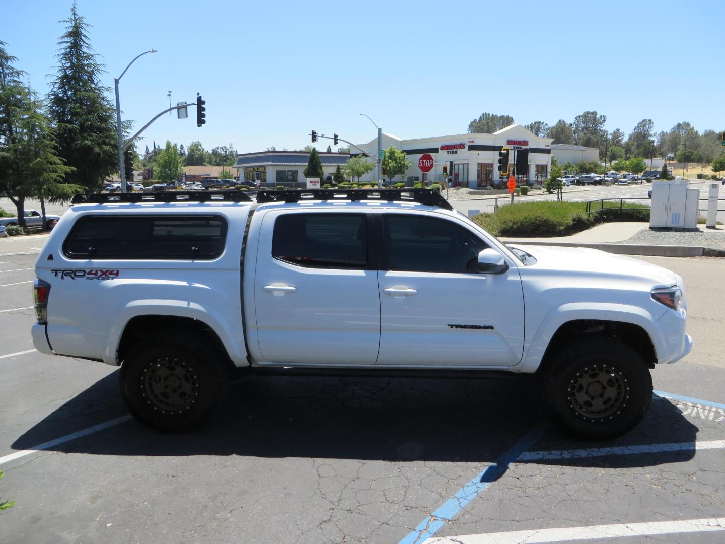 2021 White Toyota Tacoma SR5 Double Cab V6 6AT 4WD (3TMCZ5AN1MM) with an 3.5L V6 DOHC 24V engine, 6A transmission, located at 2630 Grass Valley Highway, Auburn, CA, 95603, (530) 508-5100, 38.937893, -121.095482 - Icon Vehicle Dynamics remote reservoir coilovers and shocks, Icon Upper control arms, 1552 wheels, Toyo AT3 tires, Rock Sliders, Victory 4x4 roof and camper shell rack, Leer Camper shell, Banks Idash. - Photo#6