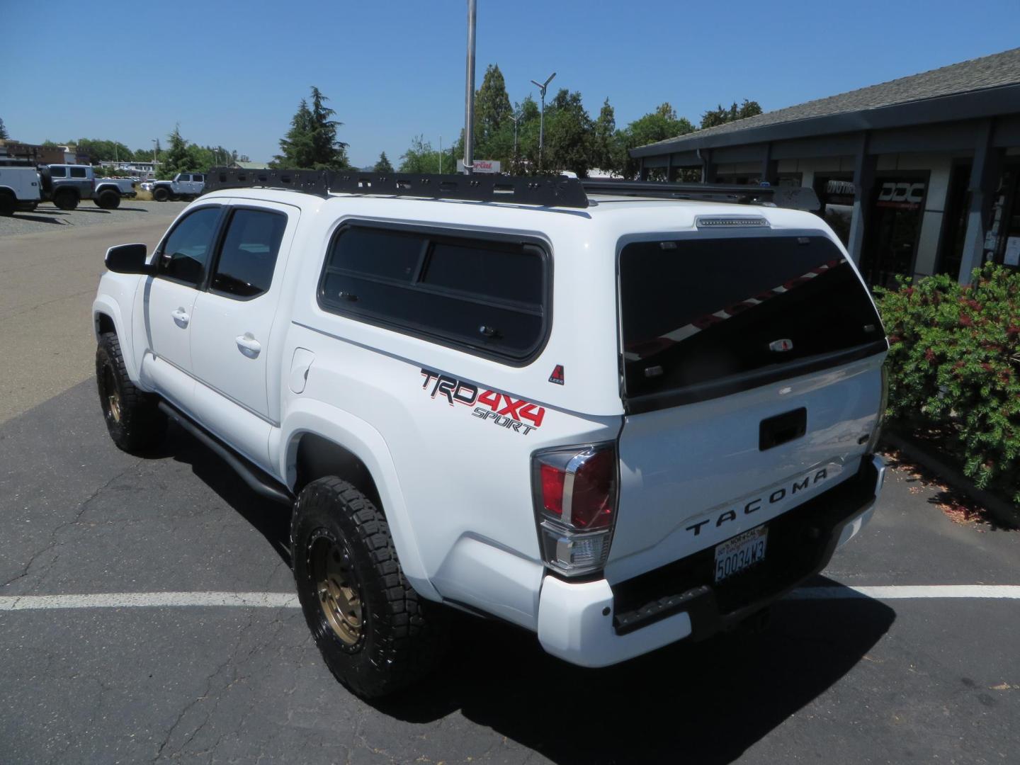 2021 White Toyota Tacoma SR5 Double Cab V6 6AT 4WD (3TMCZ5AN1MM) with an 3.5L V6 DOHC 24V engine, 6A transmission, located at 2630 Grass Valley Highway, Auburn, CA, 95603, (530) 508-5100, 38.937893, -121.095482 - Icon Vehicle Dynamics remote reservoir coilovers and shocks, Icon Upper control arms, 1552 wheels, Toyo AT3 tires, Rock Sliders, Victory 4x4 roof and camper shell rack, Leer Camper shell, Banks Idash. - Photo#12