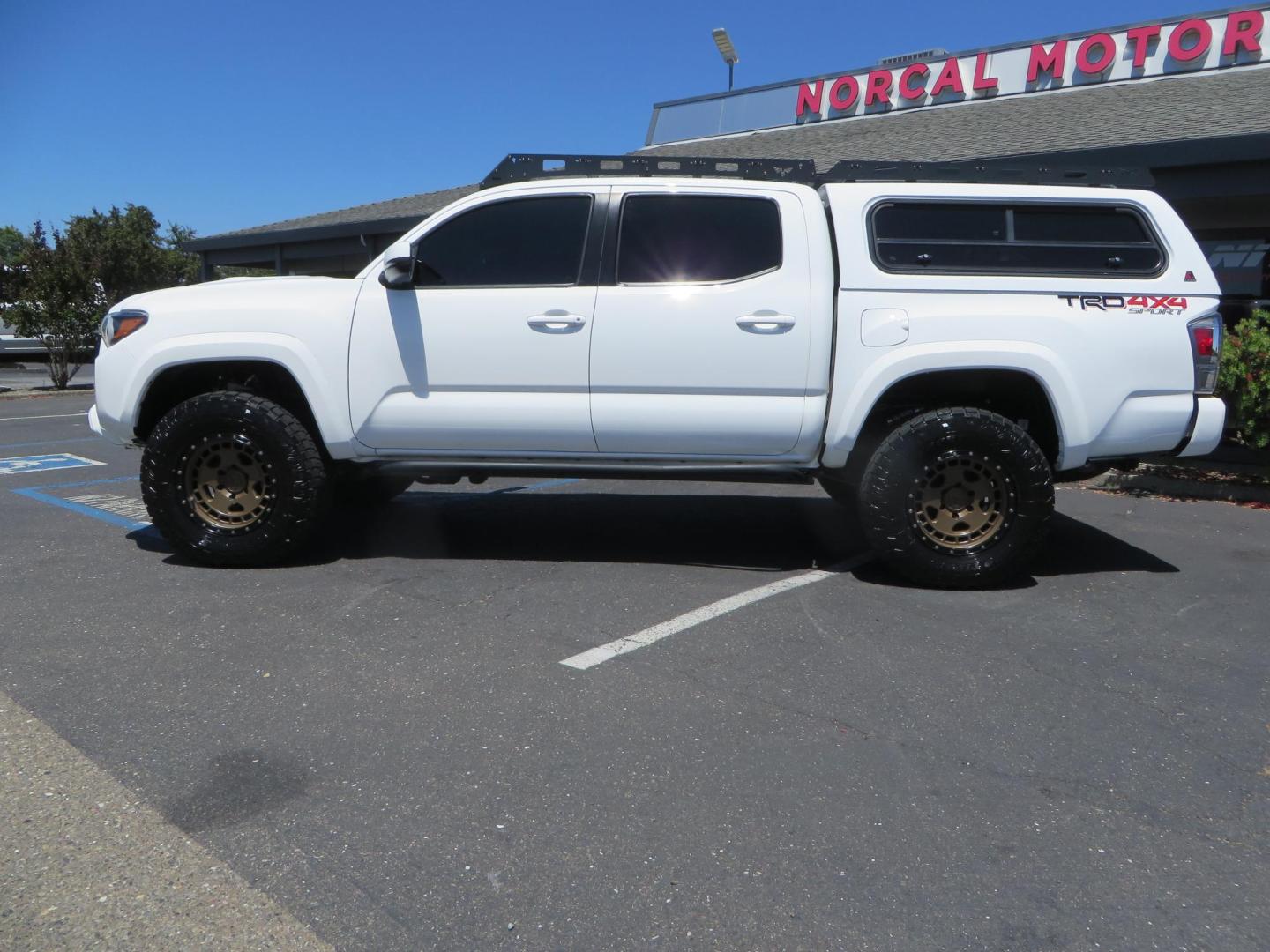 2021 White Toyota Tacoma SR5 Double Cab V6 6AT 4WD (3TMCZ5AN1MM) with an 3.5L V6 DOHC 24V engine, 6A transmission, located at 2630 Grass Valley Highway, Auburn, CA, 95603, (530) 508-5100, 38.937893, -121.095482 - Icon Vehicle Dynamics remote reservoir coilovers and shocks, Icon Upper control arms, 1552 wheels, Toyo AT3 tires, Rock Sliders, Victory 4x4 roof and camper shell rack, Leer Camper shell, Banks Idash. - Photo#13