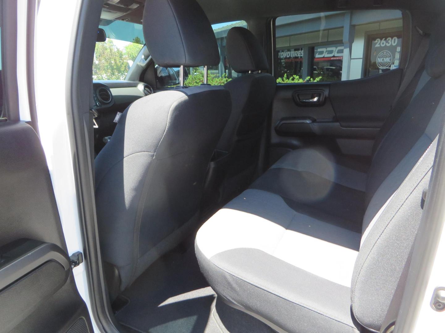 2021 White Toyota Tacoma SR5 Double Cab V6 6AT 4WD (3TMCZ5AN1MM) with an 3.5L V6 DOHC 24V engine, 6A transmission, located at 2630 Grass Valley Highway, Auburn, CA, 95603, (530) 508-5100, 38.937893, -121.095482 - Icon Vehicle Dynamics remote reservoir coilovers and shocks, Icon Upper control arms, 1552 wheels, Toyo AT3 tires, Rock Sliders, Victory 4x4 roof and camper shell rack, Leer Camper shell, Banks Idash. - Photo#49