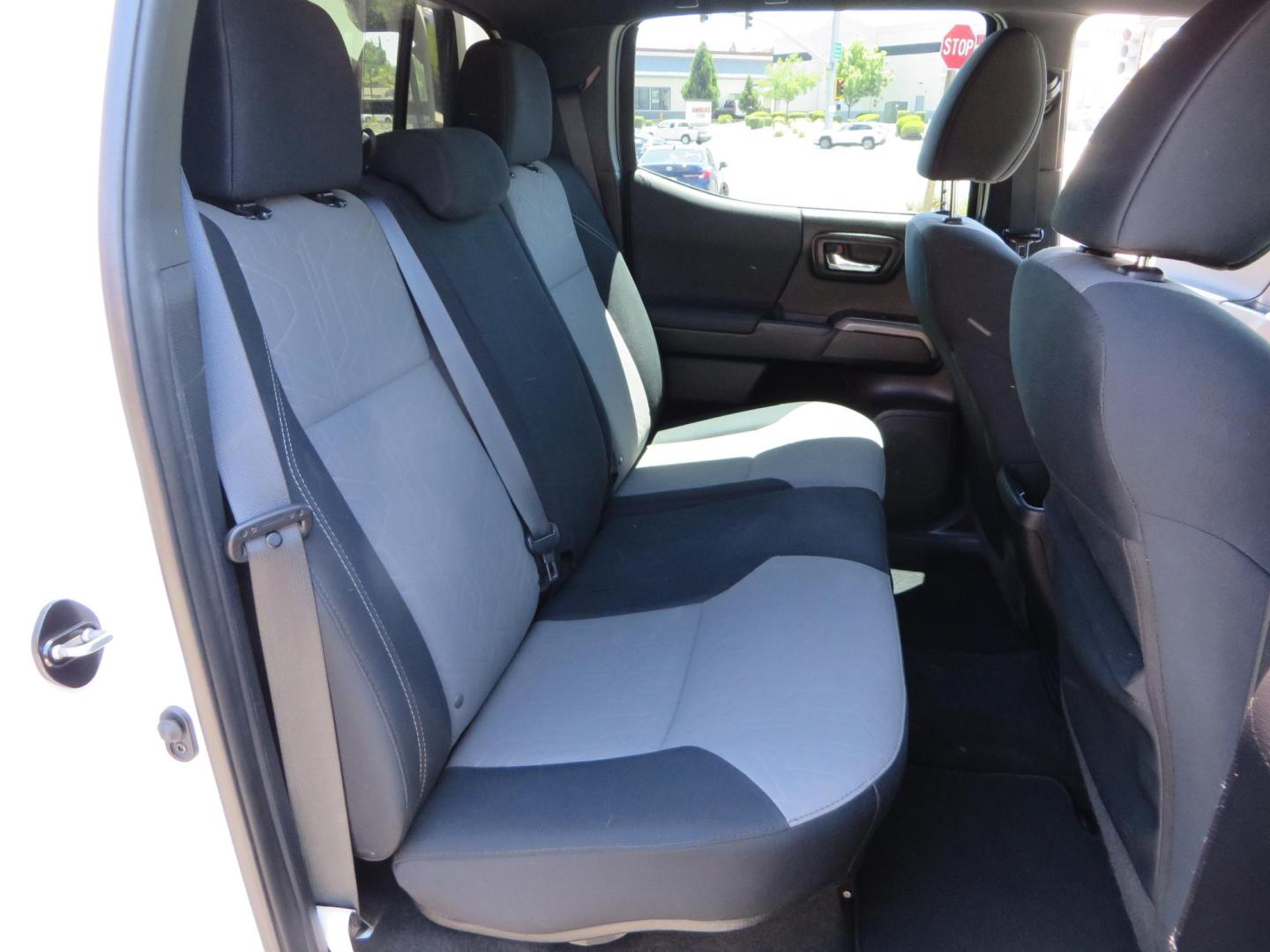 2021 White Toyota Tacoma SR5 Double Cab V6 6AT 4WD (3TMCZ5AN1MM) with an 3.5L V6 DOHC 24V engine, 6A transmission, located at 2630 Grass Valley Highway, Auburn, CA, 95603, (530) 508-5100, 38.937893, -121.095482 - Icon Vehicle Dynamics remote reservoir coilovers and shocks, Icon Upper control arms, 1552 wheels, Toyo AT3 tires, Rock Sliders, Victory 4x4 roof and camper shell rack, Leer Camper shell, Banks Idash. - Photo#53