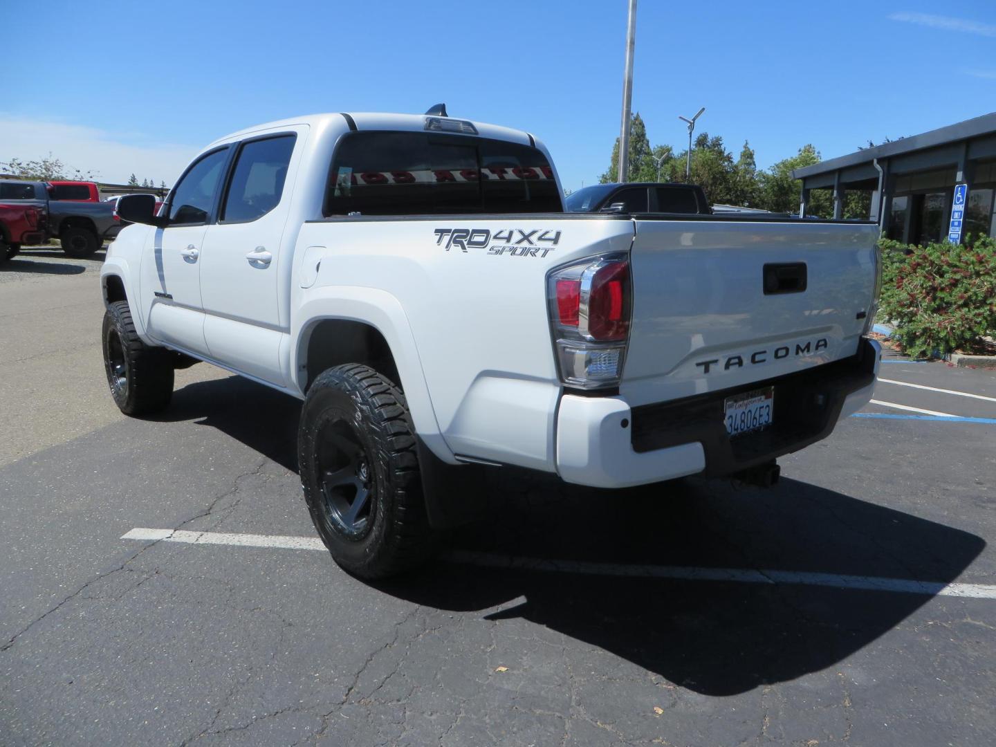 2021 White Toyota Tacoma SR5 Double Cab V6 6AT 4WD (3TYCZ5AN8MT) with an 3.5L V6 DOHC 24V engine, 6A transmission, located at 2630 Grass Valley Highway, Auburn, CA, 95603, (530) 508-5100, 38.937893, -121.095482 - Leveled Tacoma sitting on 18" Fuel wheels, Toyo RT tires, and window tint. - Photo#6
