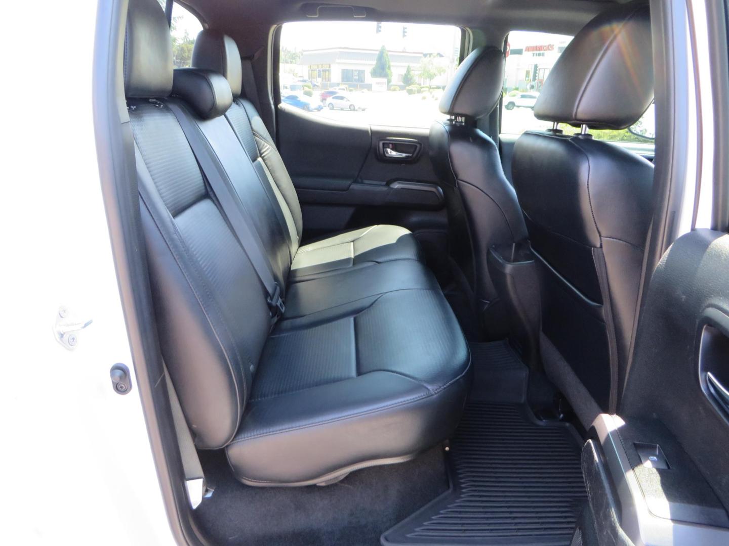 2021 White Toyota Tacoma SR5 Double Cab V6 6AT 4WD (3TYCZ5AN8MT) with an 3.5L V6 DOHC 24V engine, 6A transmission, located at 2630 Grass Valley Highway, Auburn, CA, 95603, (530) 508-5100, 38.937893, -121.095482 - Leveled Tacoma sitting on 18" Fuel wheels, Toyo RT tires, and window tint. - Photo#50